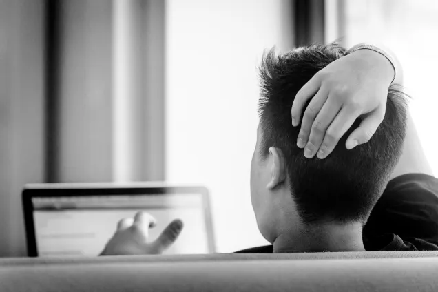 Picture of student facing away with one arm over their head. Photo by Kennet Ruona.