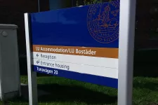 A blue brown and white sign that says LU Accommodation/LU Bostäder on the first row, Reception on the second row, entrance housing on the third row and Tunavägen 20 on the  forth row (picture)