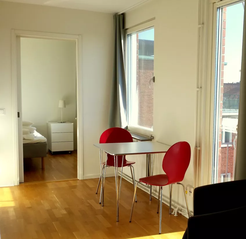 A view of a kitchen table with the bedroom in the background at the housing area Folkets park in the city of Malmö (picture).