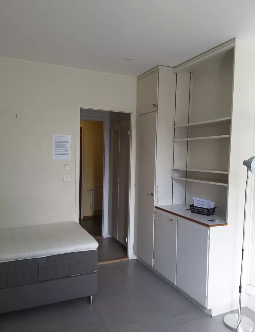 Overview of room F1102 at housing area Michael Hansen  showing the bed, wardrobe, hallway and toilet door.