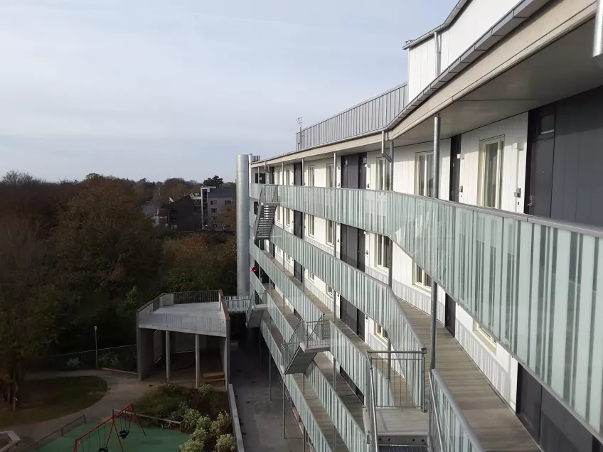 The view from the top floor at the housing area Sofieberg showing the building to the right and the park to the left (picture)