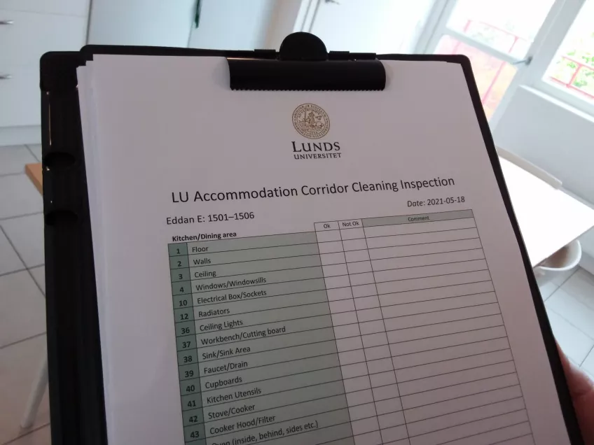 A picture of a inspection report on a clipboard. The inspection report says "LU Accommodation Corridor Cleaning Inspection" and has the Lund university Logo at the top. Below there are items in a list, the corridor name and date of the inspection. (picture)